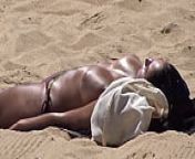 Brunette with big tanned boobs at the beach from topless tanning sweety